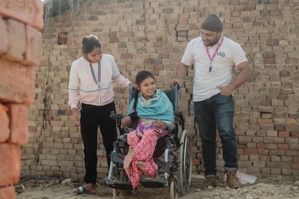 Girl in wheelchair with volunteers