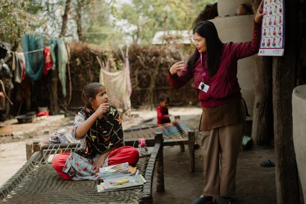 Izna being mentored by a sign-language interpreter.