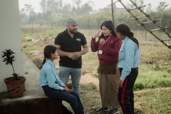 Nitin with mentor and schoolgirls