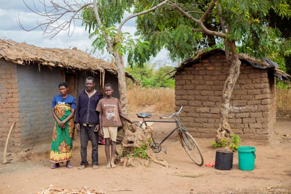 Family outside a small hut