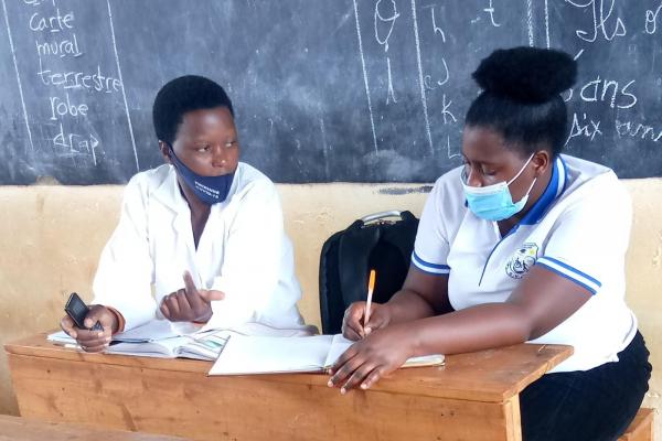 Volunteer Diane teaches teacher Berthilde about inclusive education.