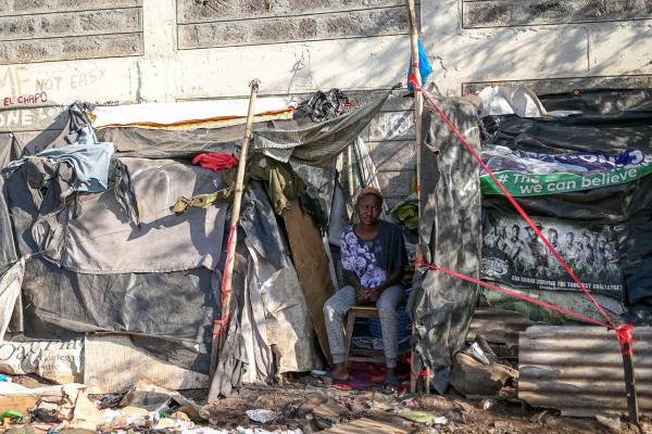 Waste picker outside makeshift home